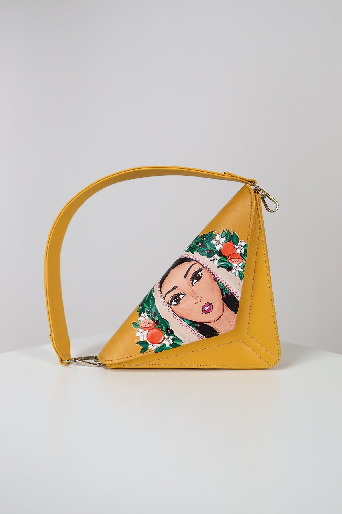 Yellow handbag with a character design on a white background