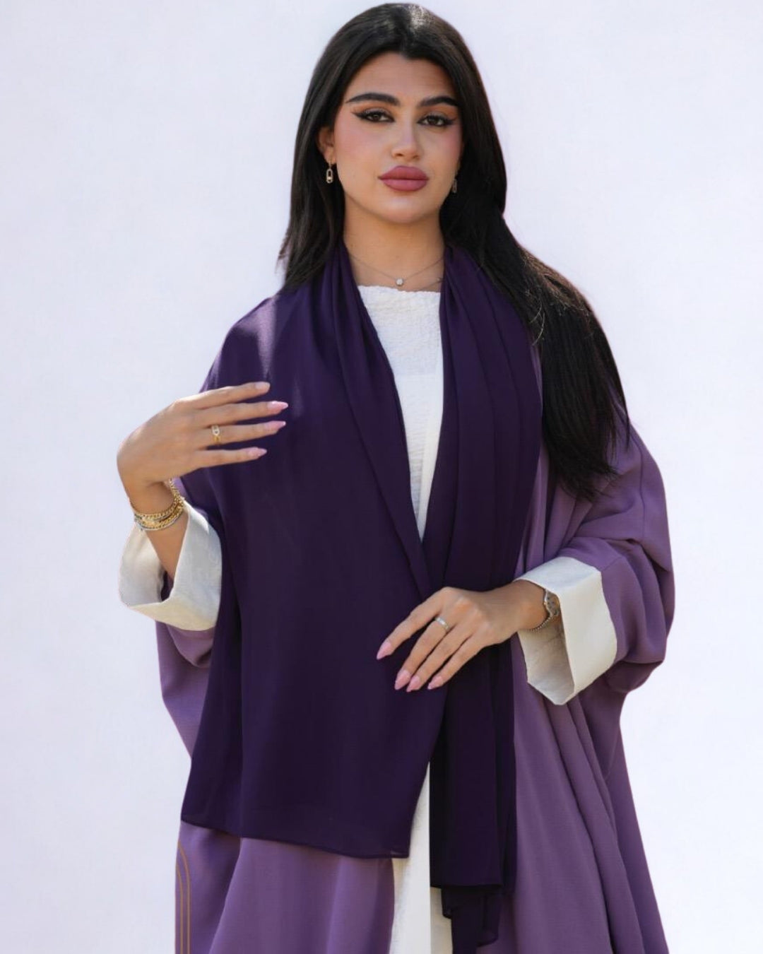 Woman wearing a purple scarf on a white background