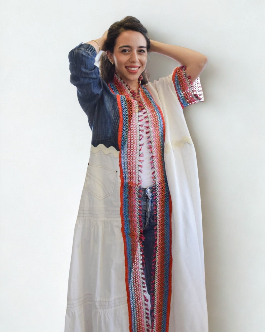 Woman wearing a long, colorful dress with a white background