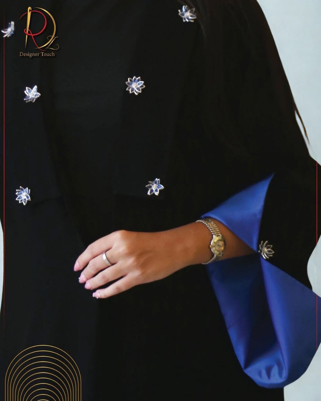 Black garment with blue accents and decorative elements, featuring a brand logo.