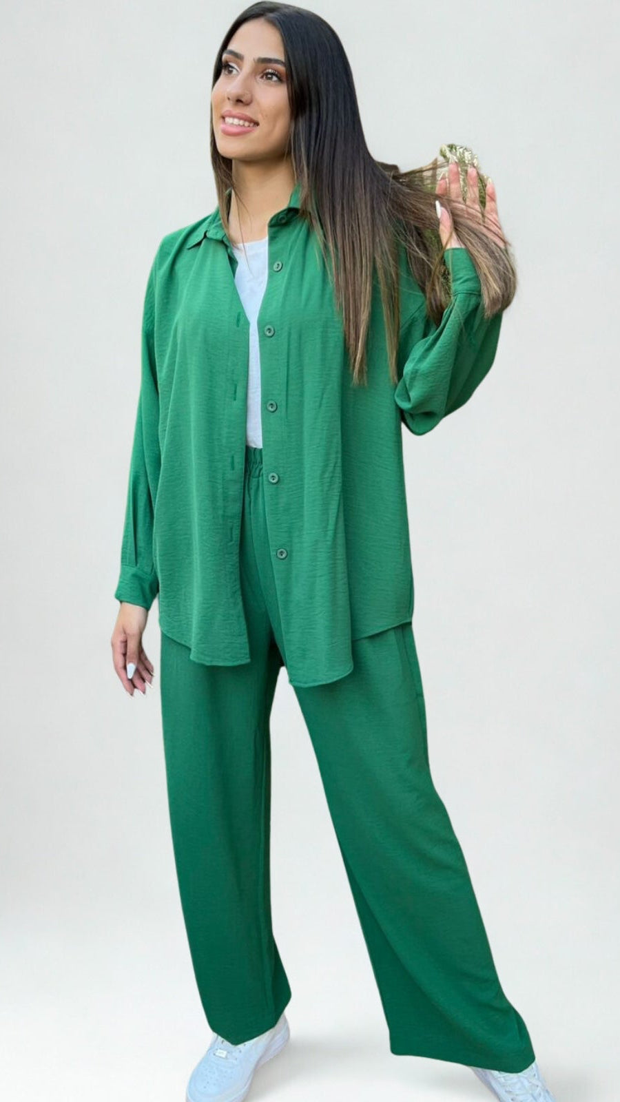 Woman wearing a green outfit on a white background