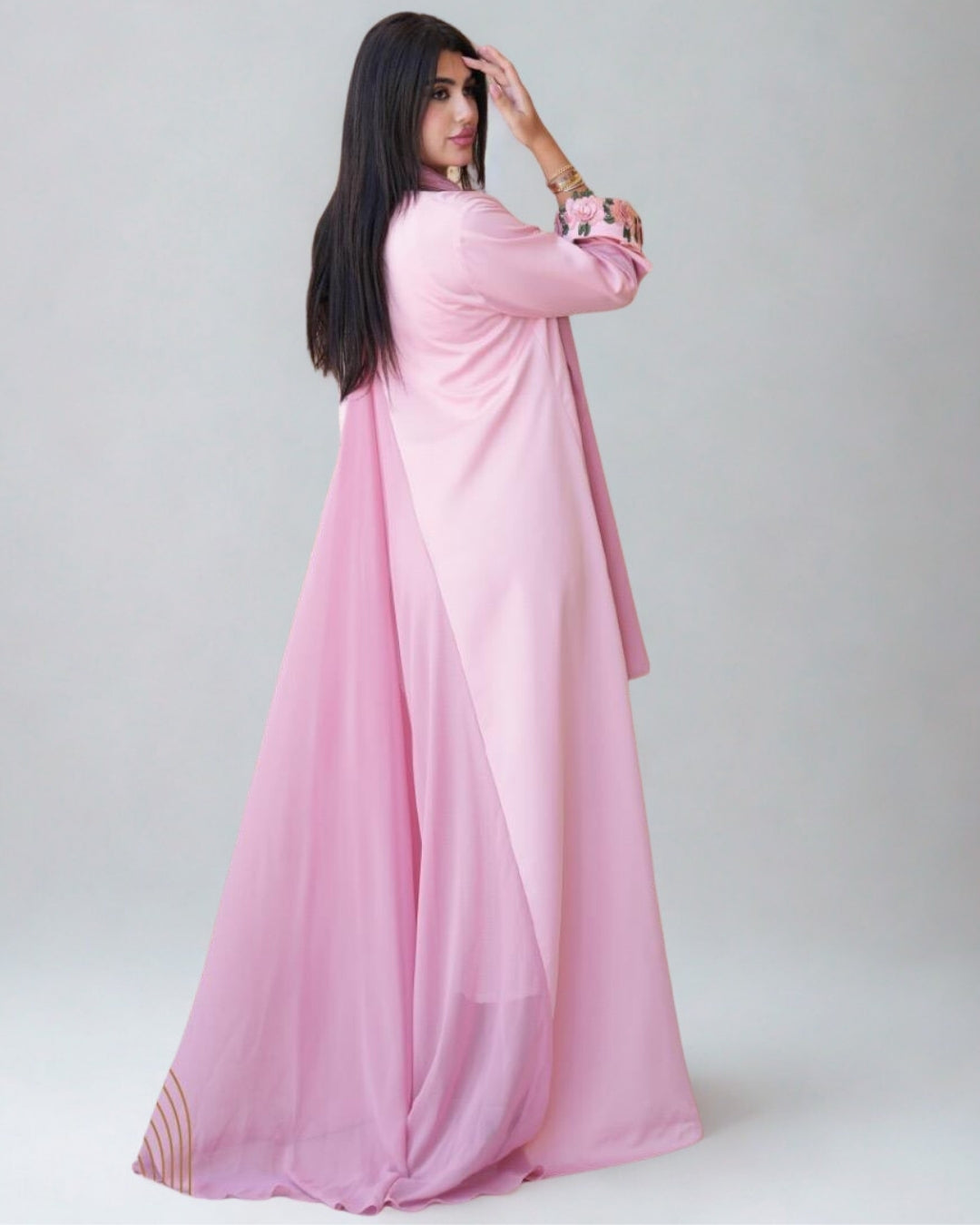 Woman wearing a pink dress against a white background