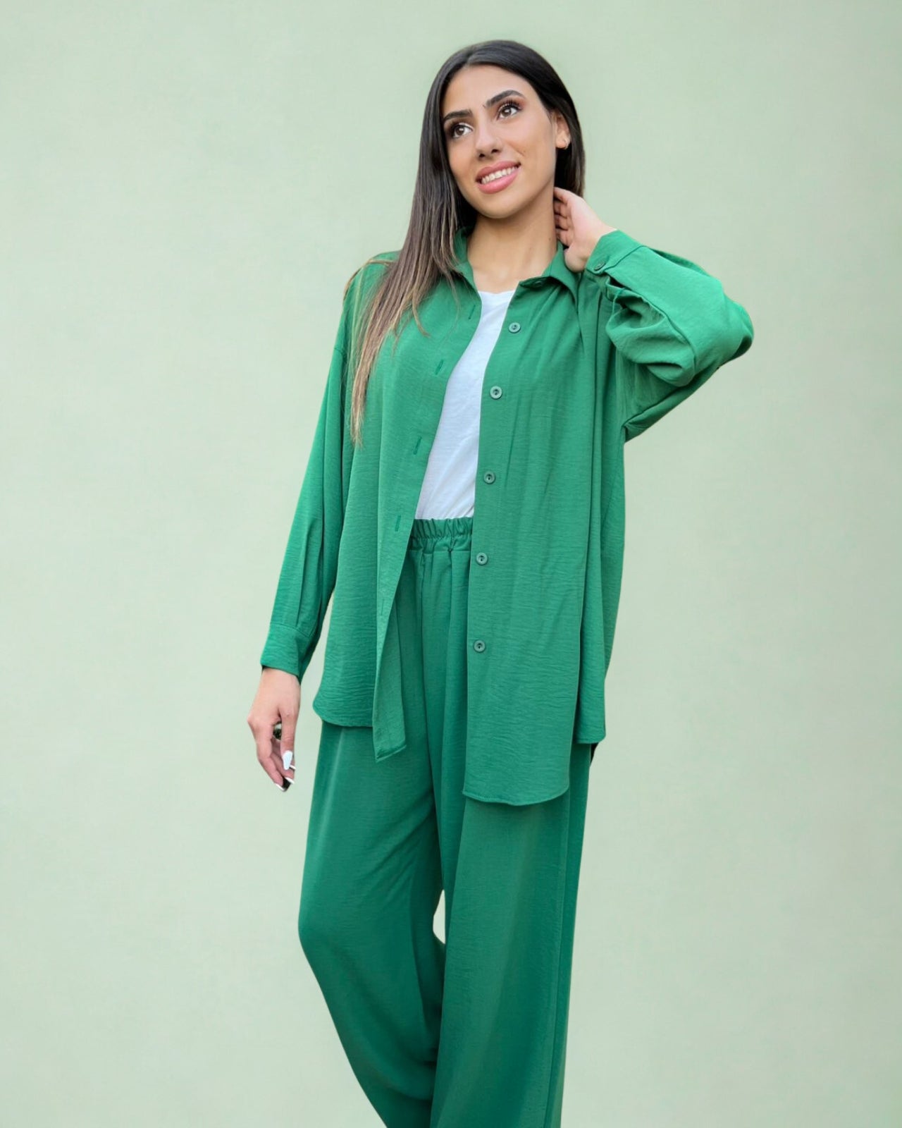 Woman wearing a green outfit against a light green background