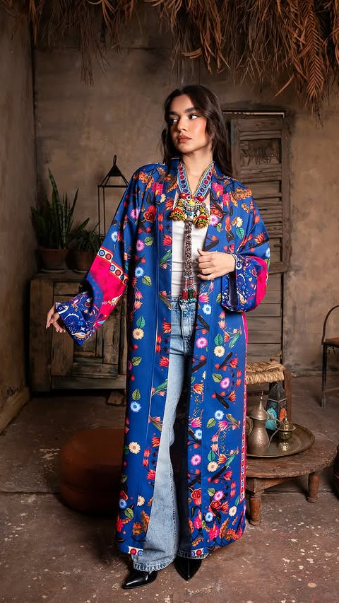 Woman wearing a colorful floral kimono in a rustic indoor setting