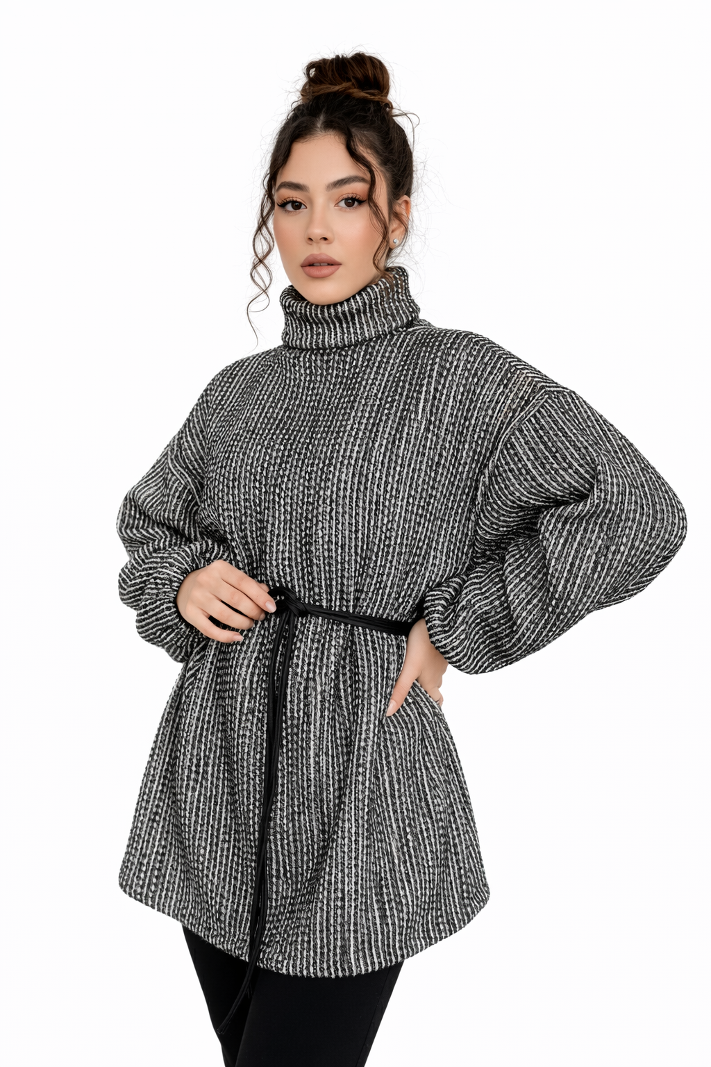 Woman wearing a black and white patterned dress with balloon sleeves on a white background