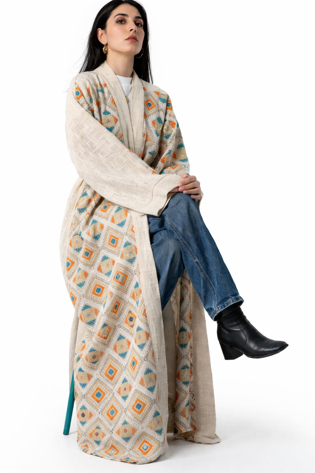 Woman wearing a long, patterned scarf with a white background