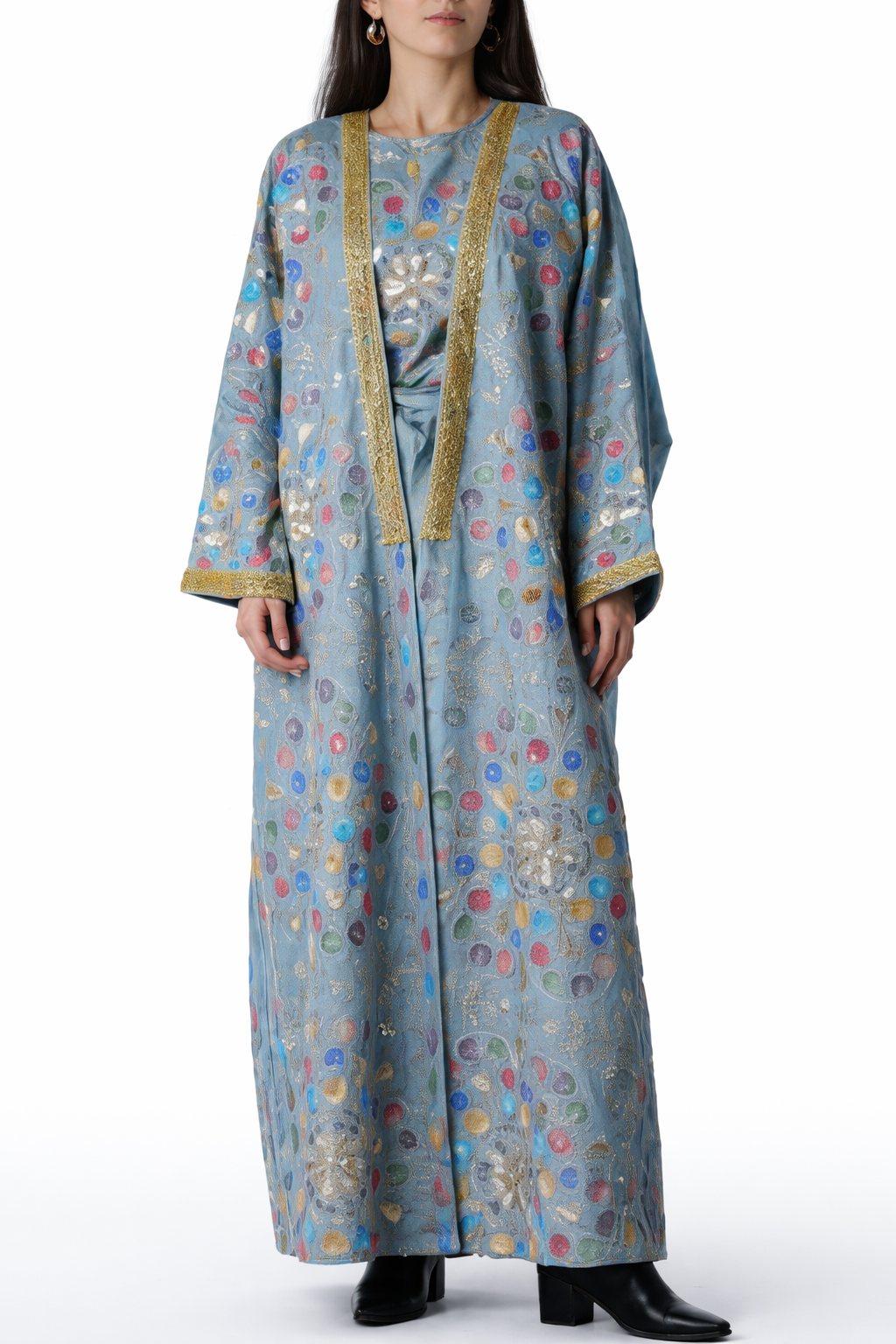 Long, patterned dress with gold accents worn by a model on a white background