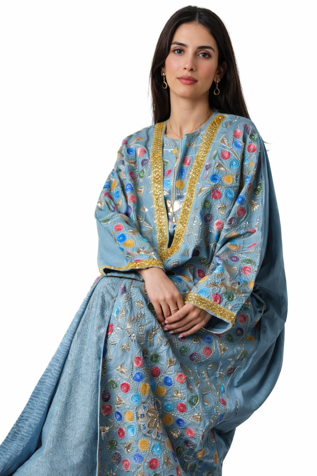 Woman wearing a blue embroidered traditional outfit on a white background