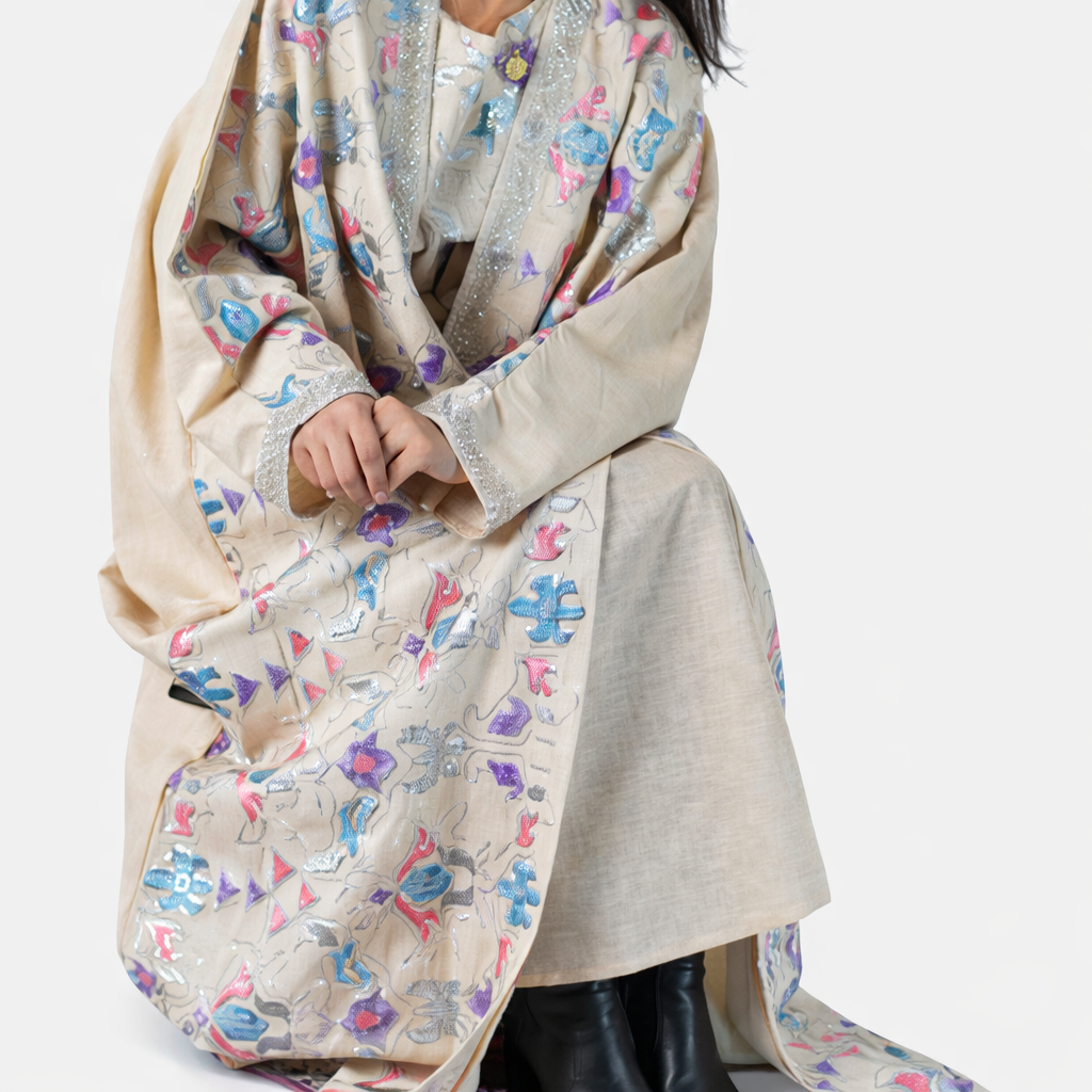 Person wearing a floral-patterned scarf draped over shoulders on a white background