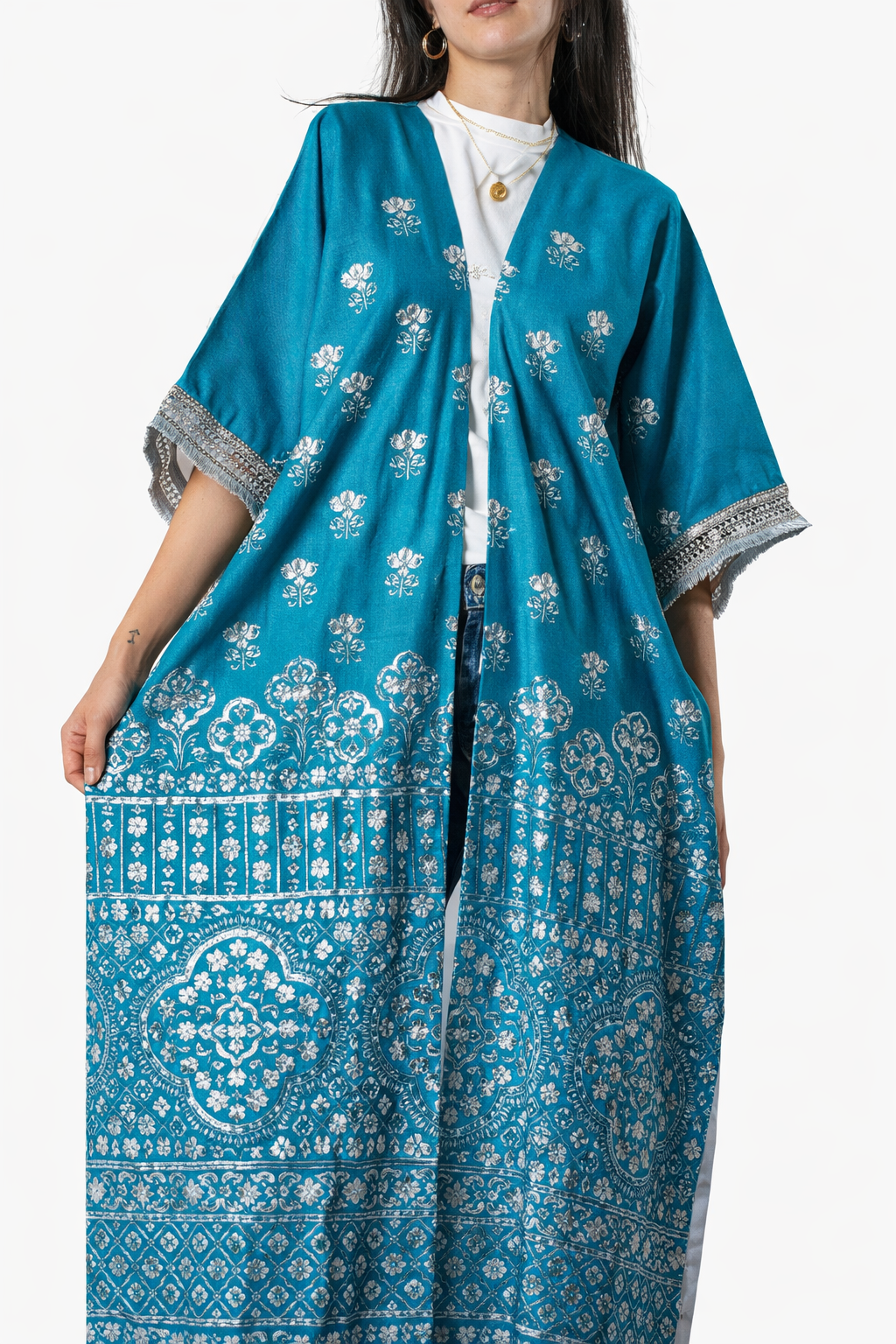 Woman wearing a blue patterned dress with a white background