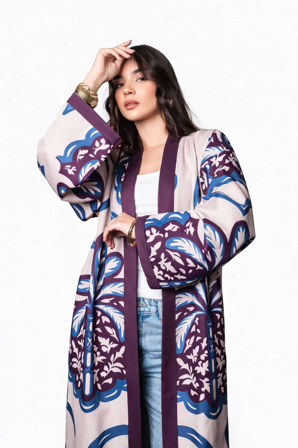 Woman wearing a patterned kimono-style outfit on a white background