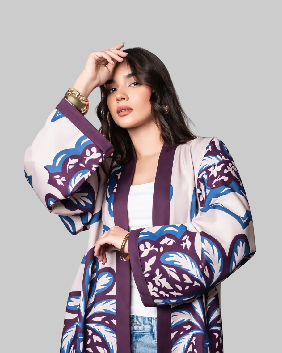 Woman wearing a patterned kimono-style outfit on a white background