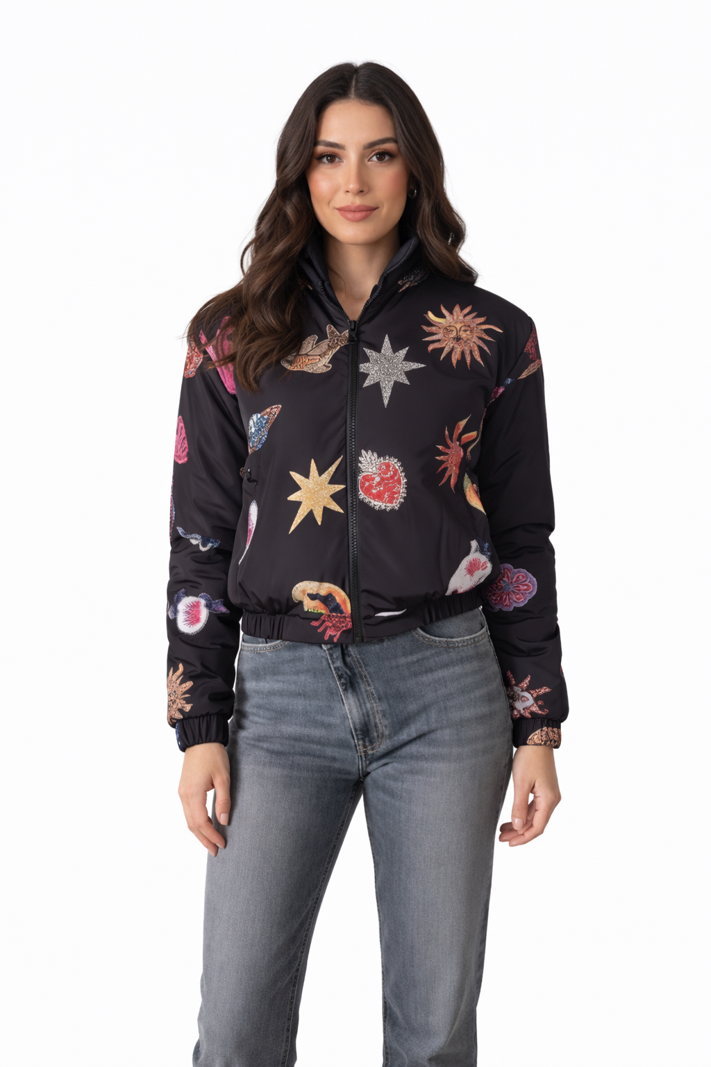 Woman wearing a black bomber jacket with colorful abstract patterns on a white background