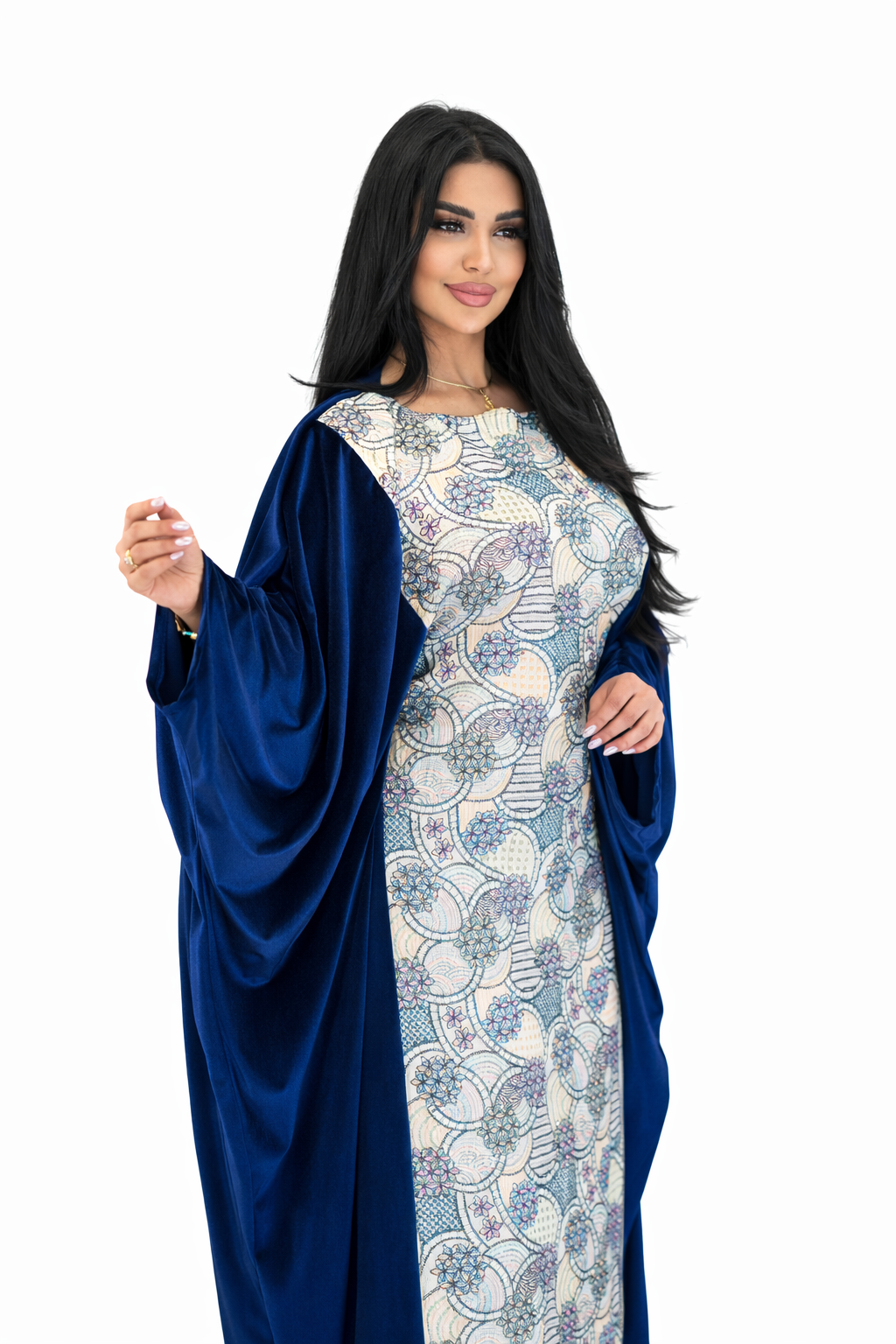 Woman wearing a blue and white patterned dress with a matching shawl on a white background