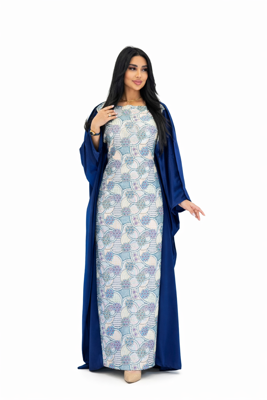 Woman wearing a blue and white patterned dress with a matching long coat on a white background