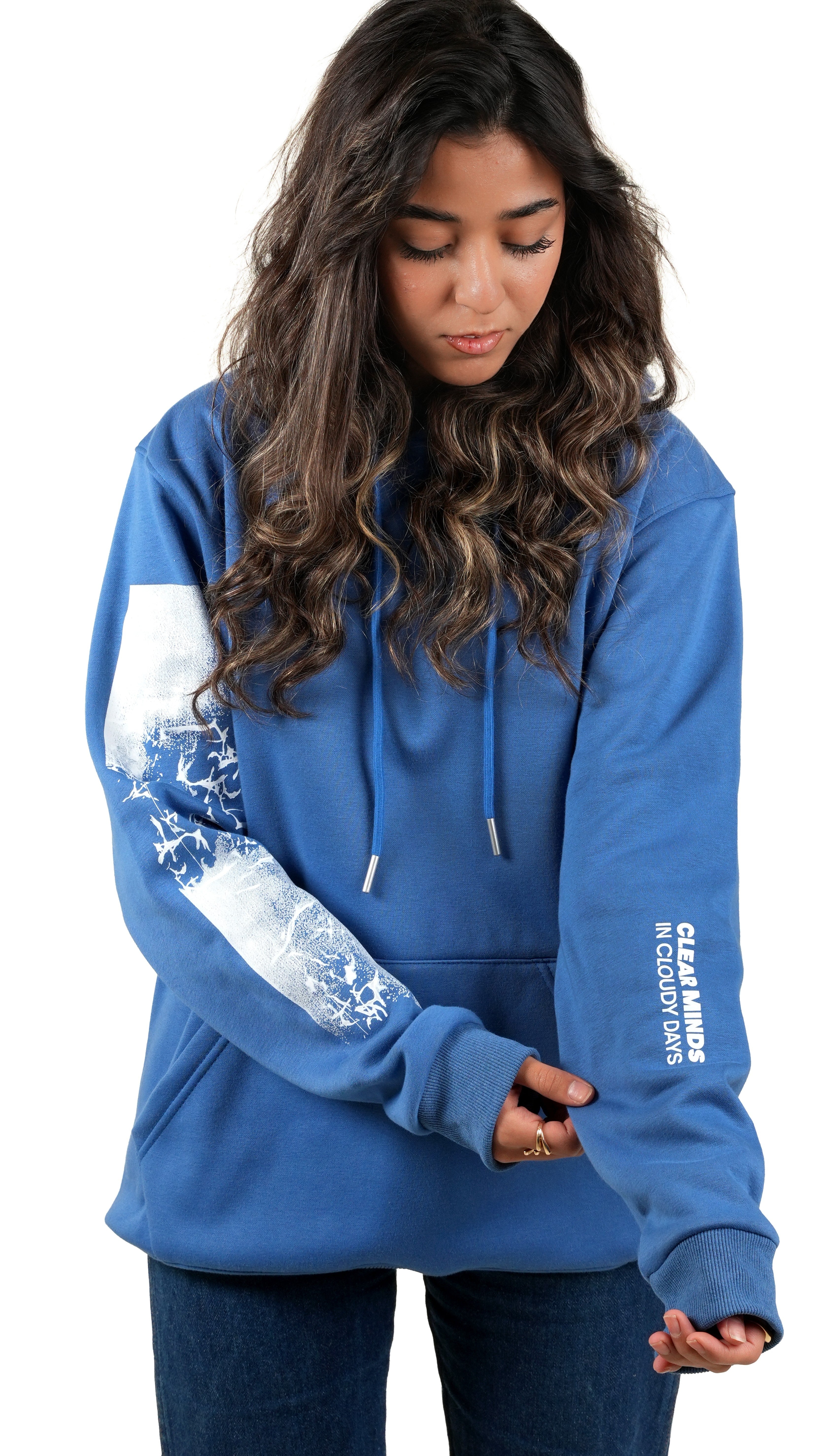 Woman wearing a blue hoodie with white arm designs and text on a white background
