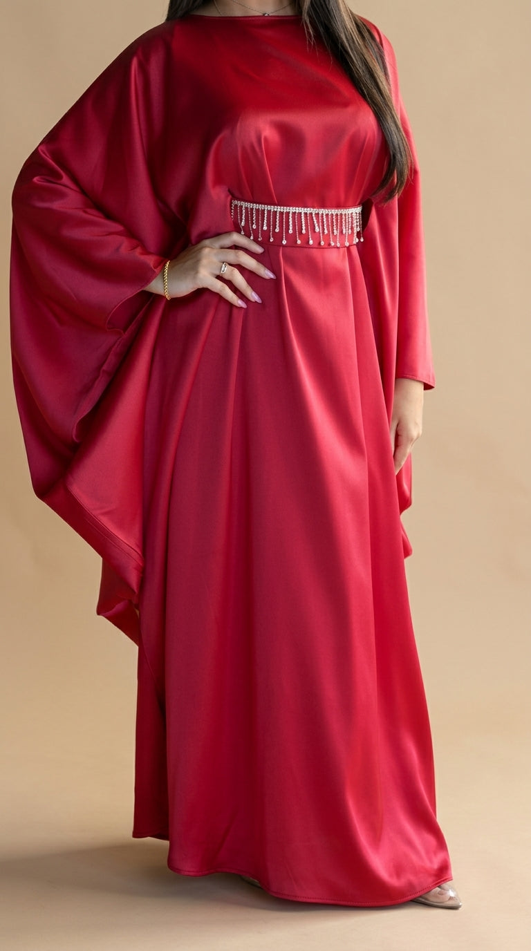 Red dress with long sleeves and a beaded waistband on a beige background