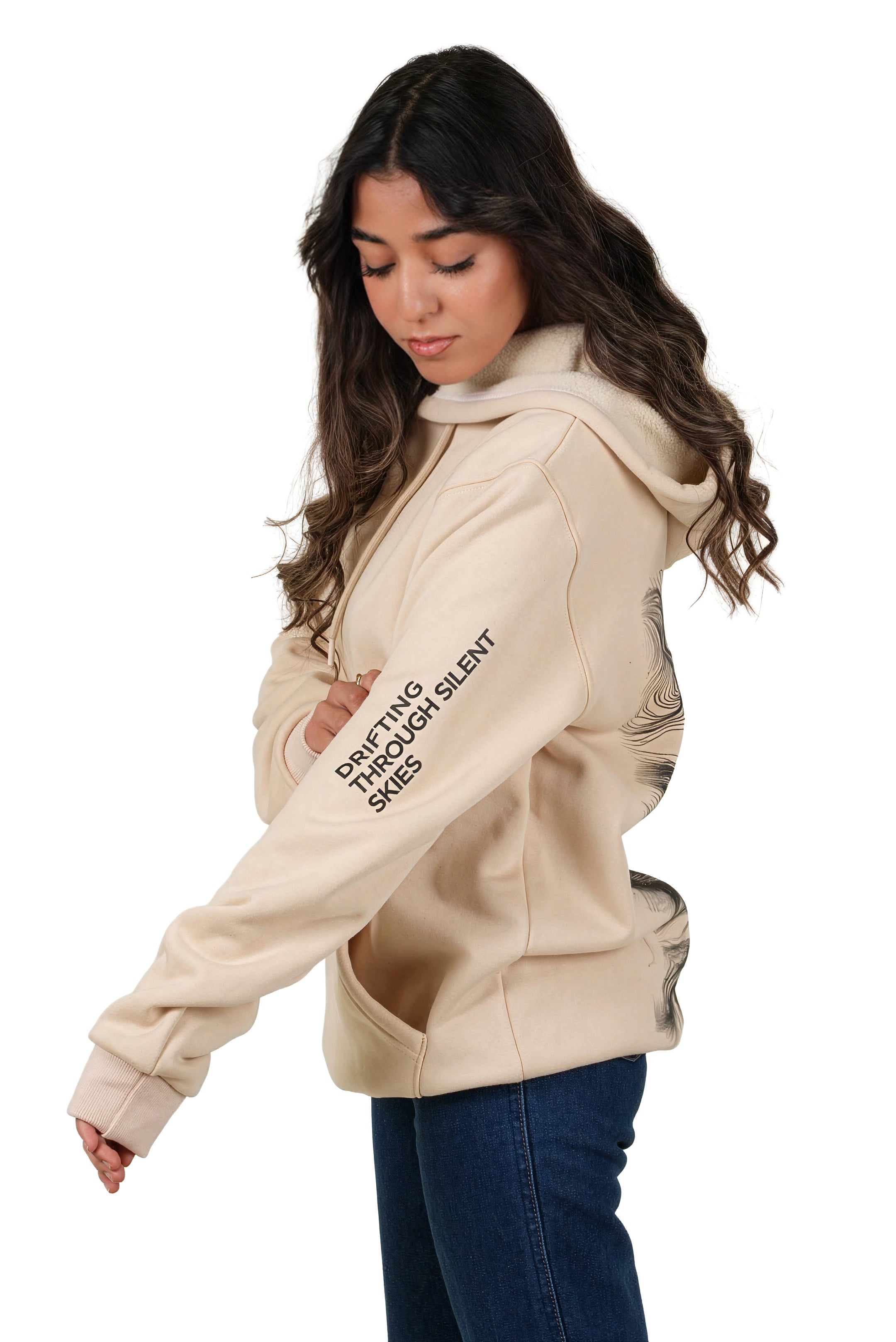 Woman wearing a beige hoodie with text on a white background