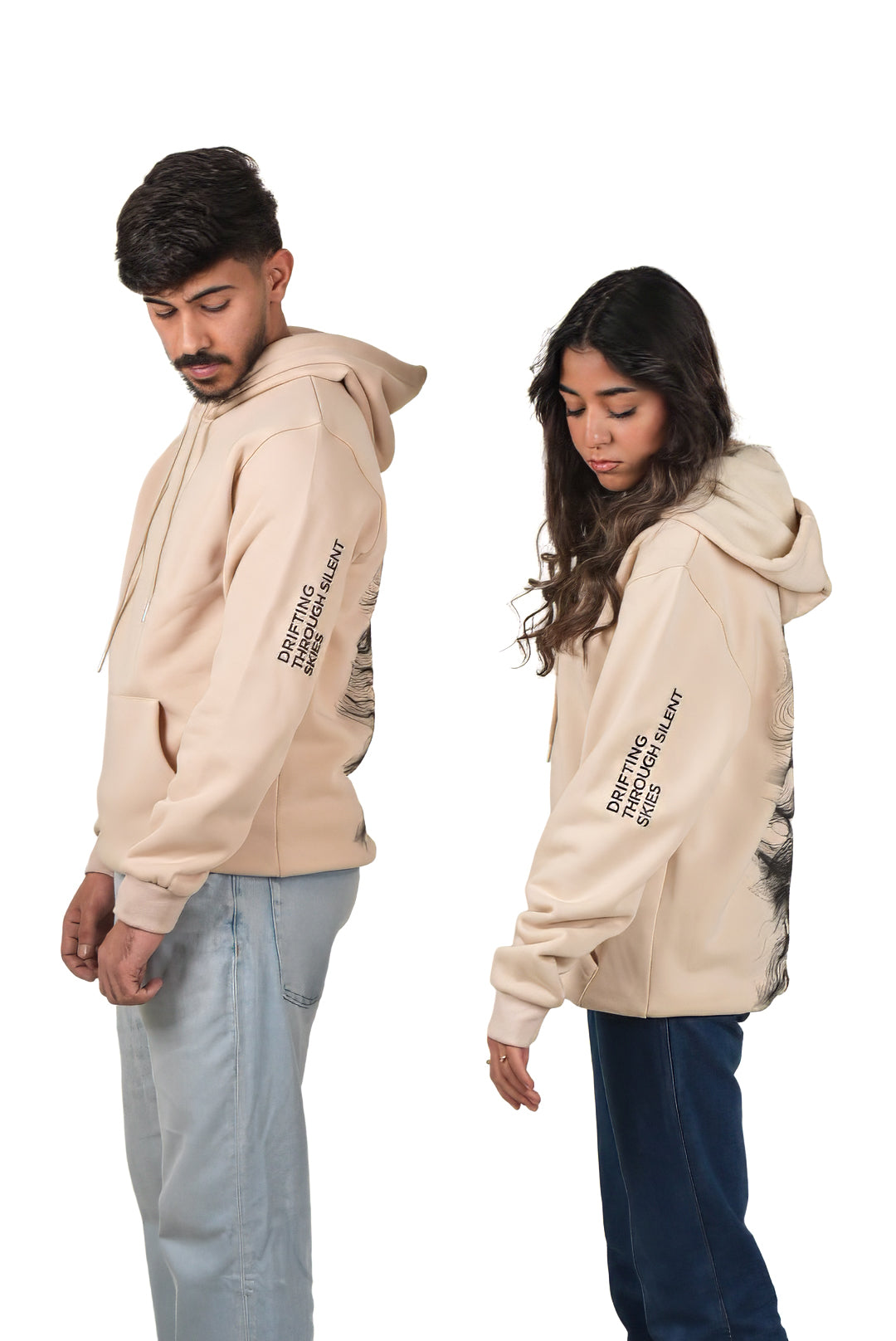 Two people wearing beige hoodies with text on sleeves against a white background