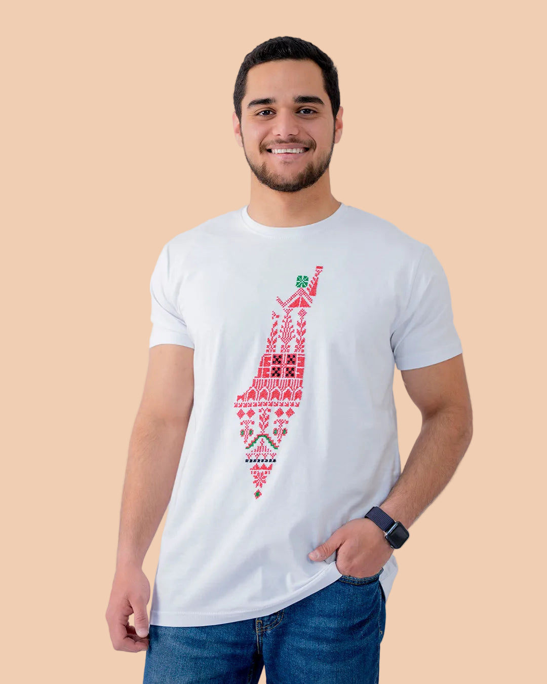 Man wearing a white t-shirt with a red geometric pattern on a plain background
