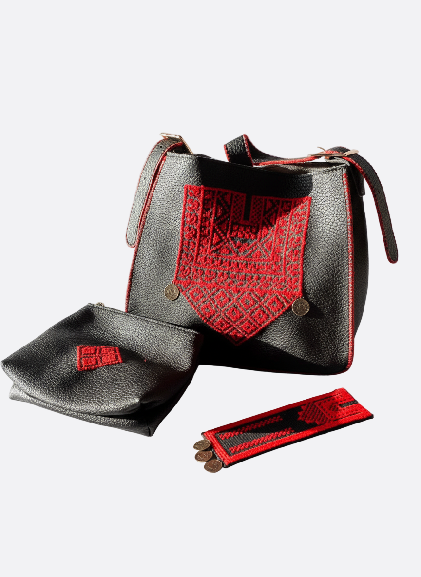 Black handbag with red accents and matching pouch on a white background