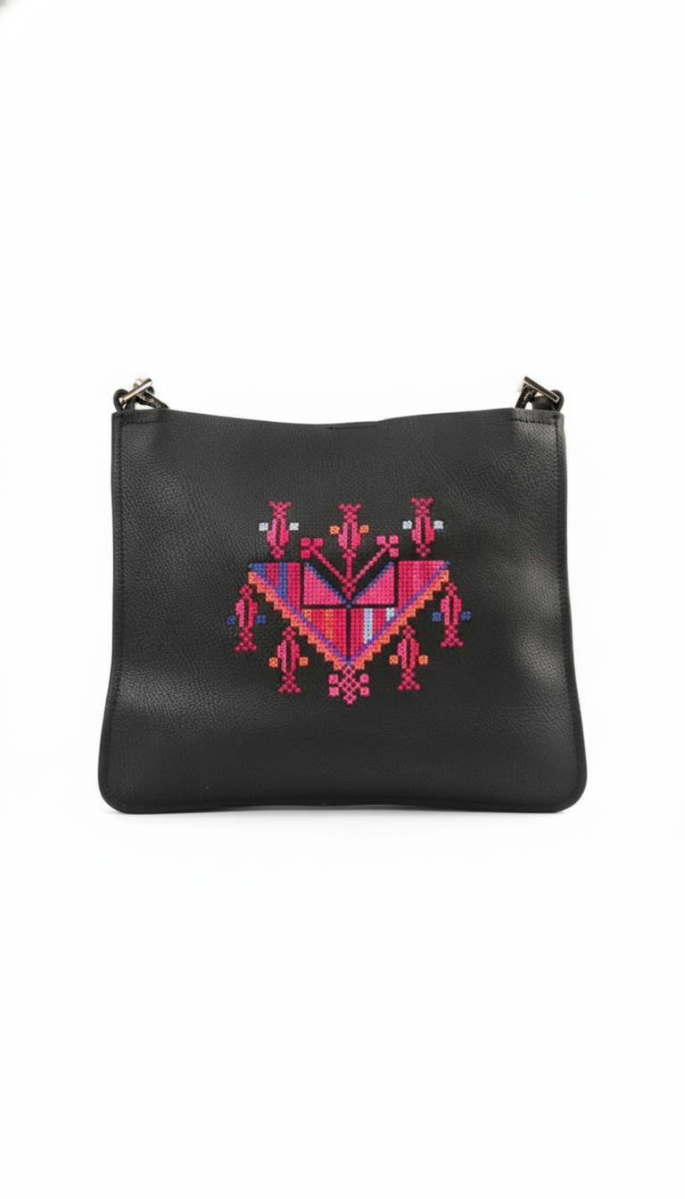 Black leather pouch with pink and red geometric embroidery on a white background