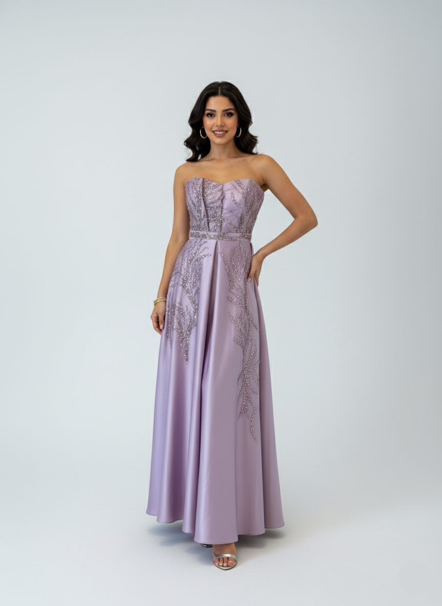 Woman wearing a strapless, embroidered lilac gown on a white background