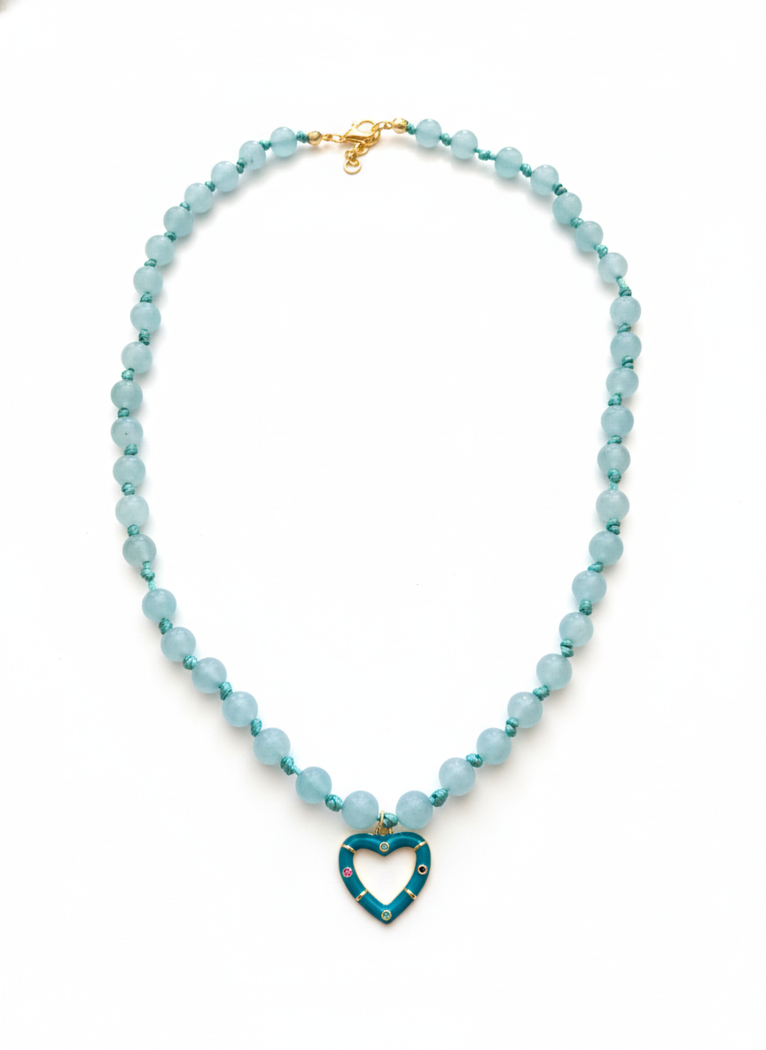 Necklace with blue beads and a heart-shaped pendant on a white background