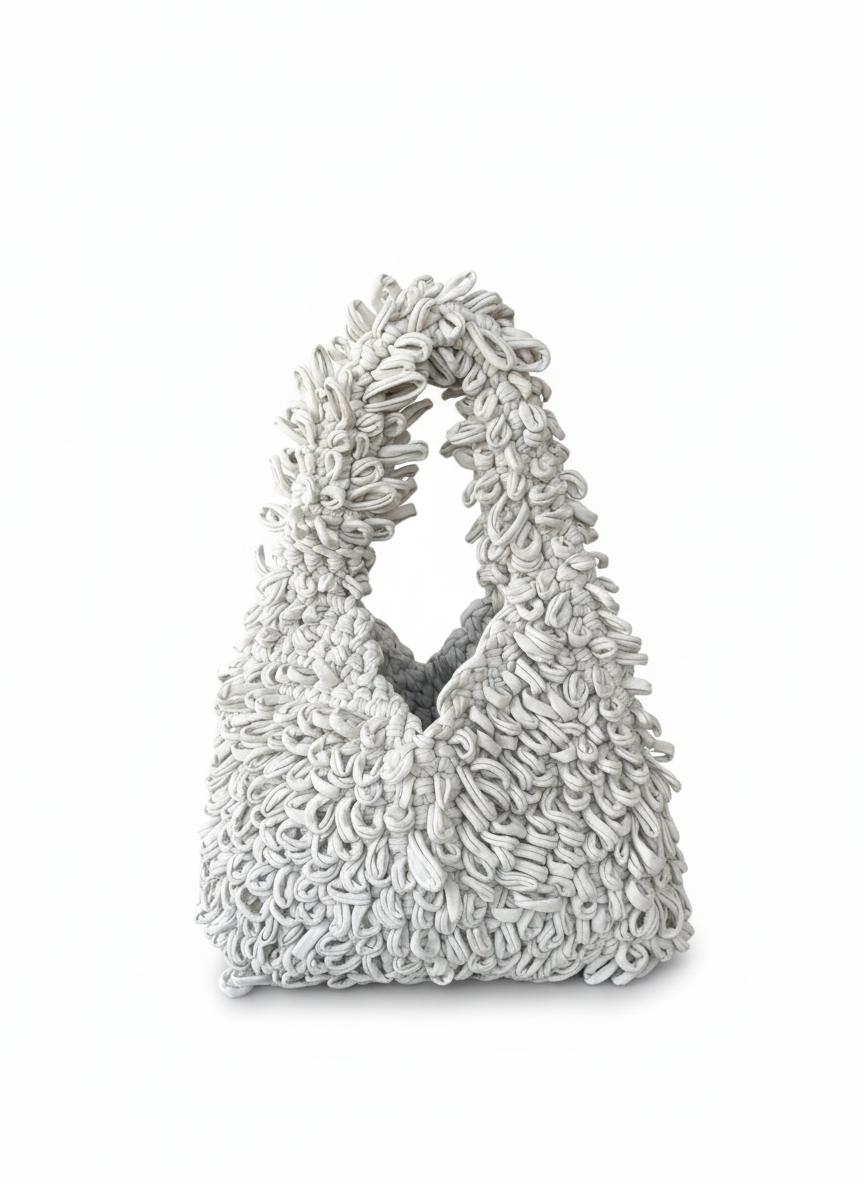 Textured handbag with a unique design on a white background