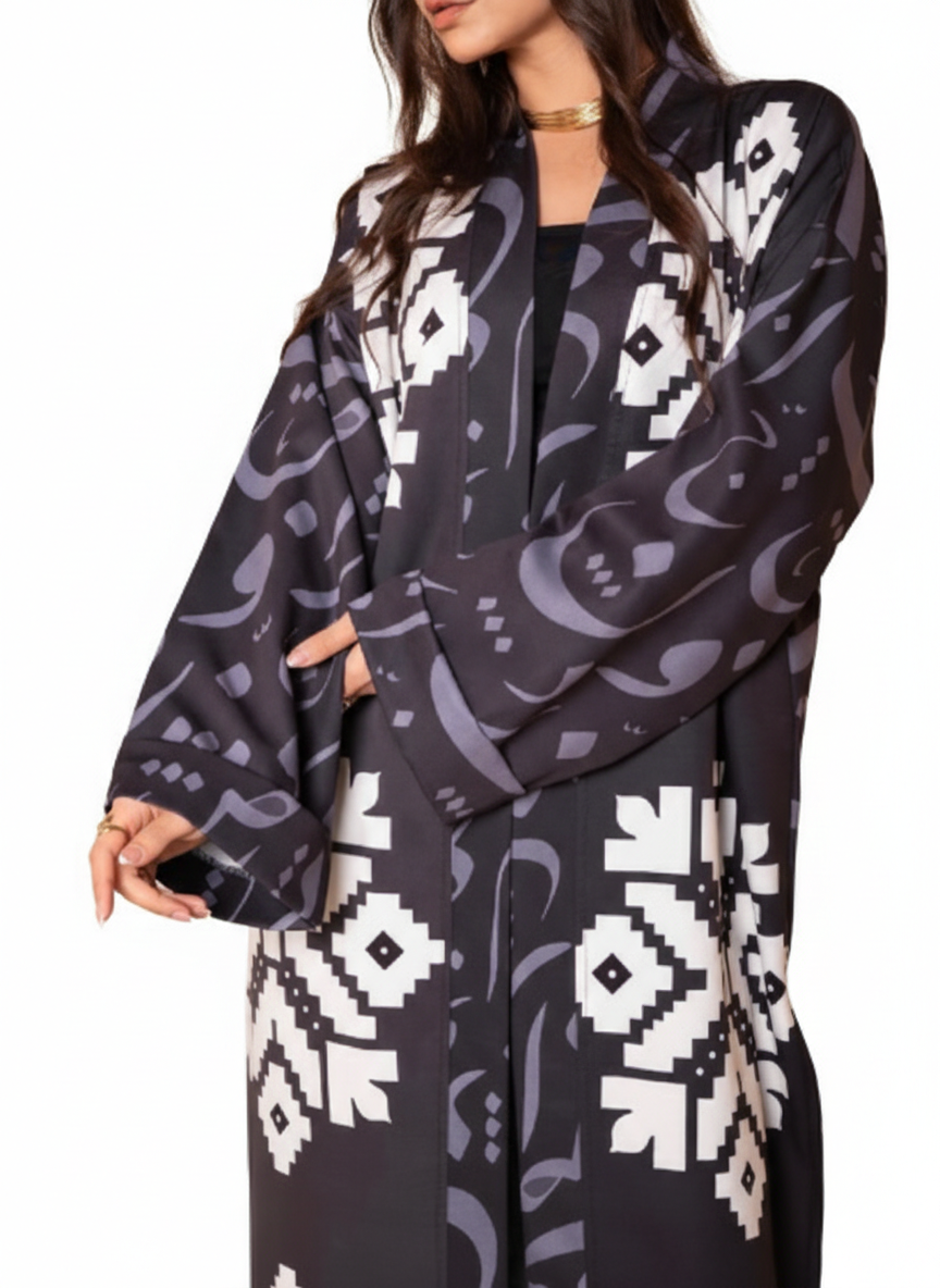 Woman wearing a black patterned kimono-style garment on a white background