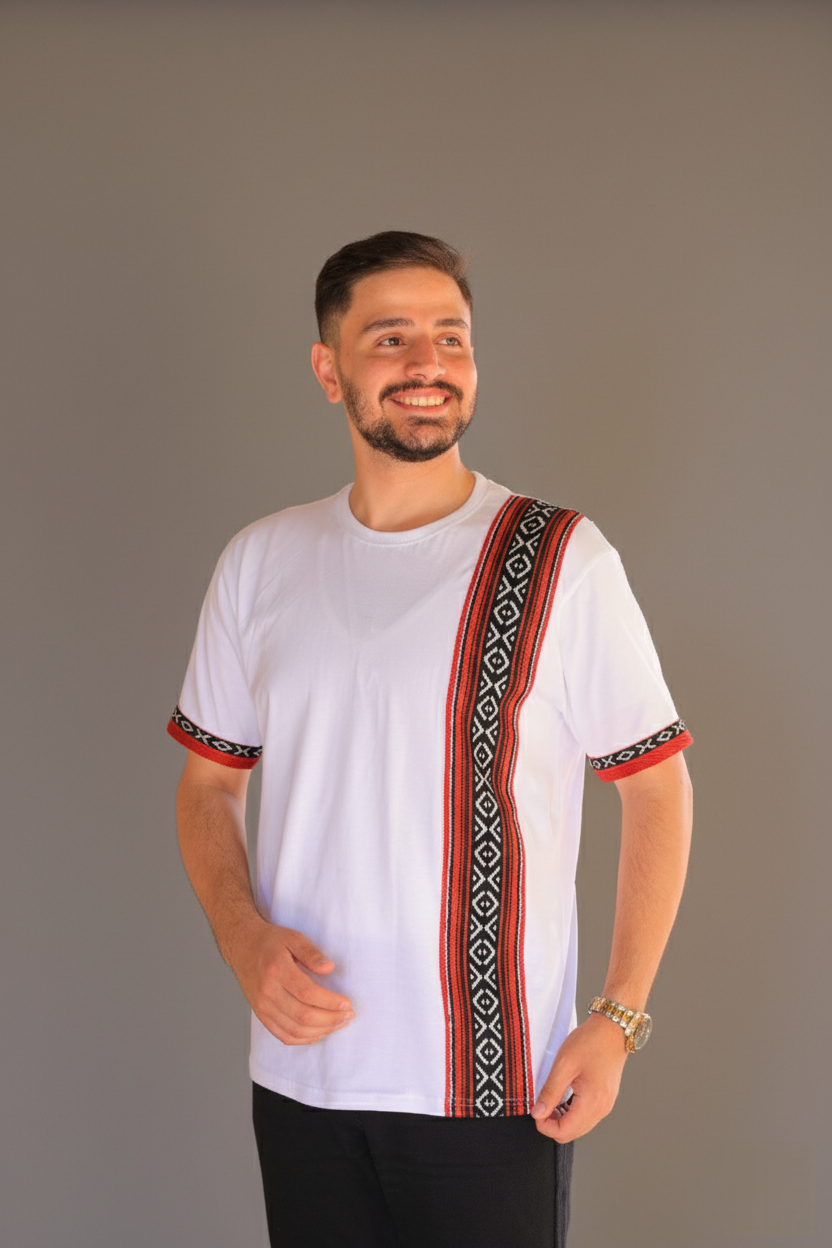 Man wearing a white shirt with colorful embroidery on a gray background
