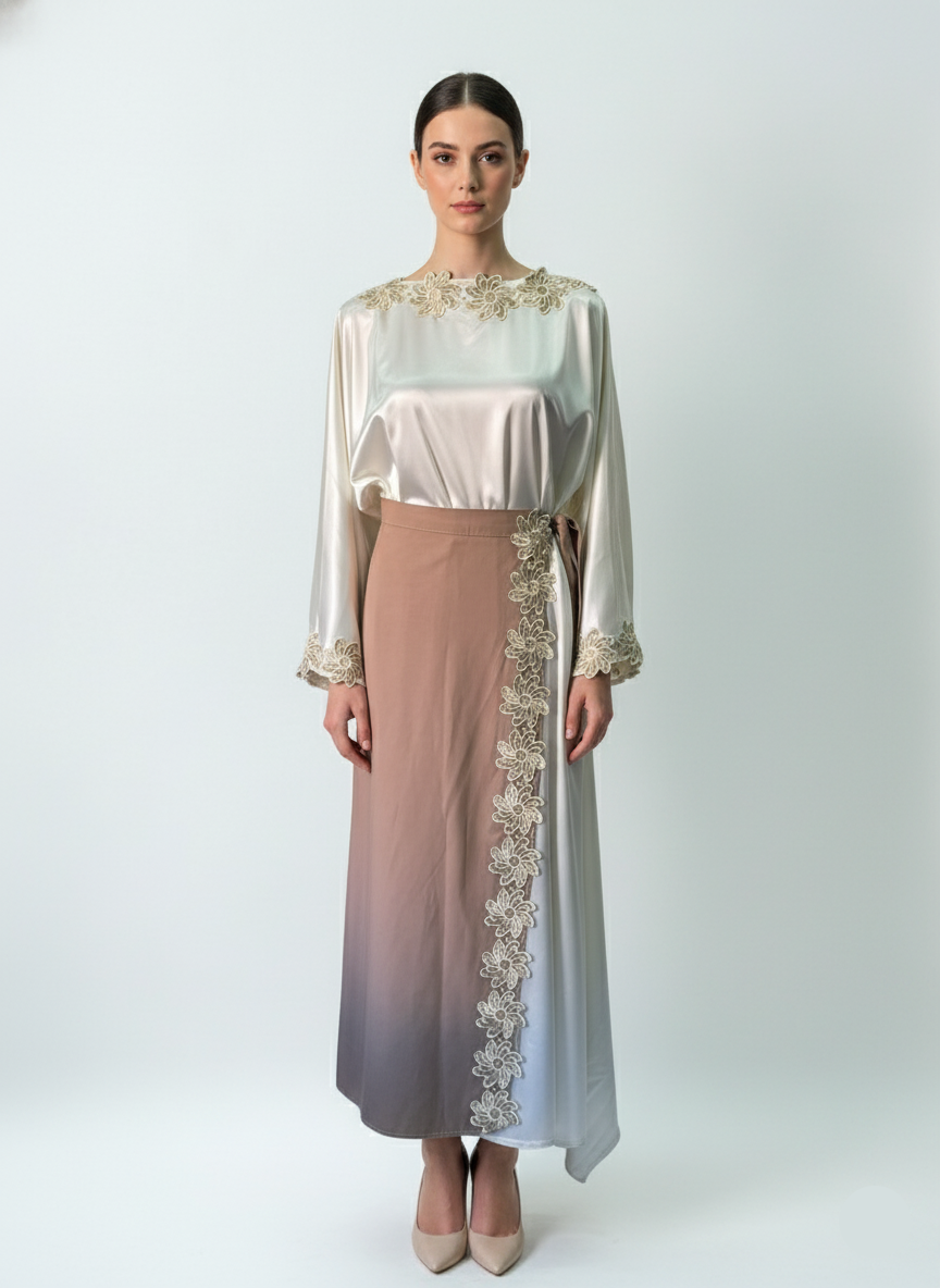 Woman wearing a long, elegant dress with lace details on a white background