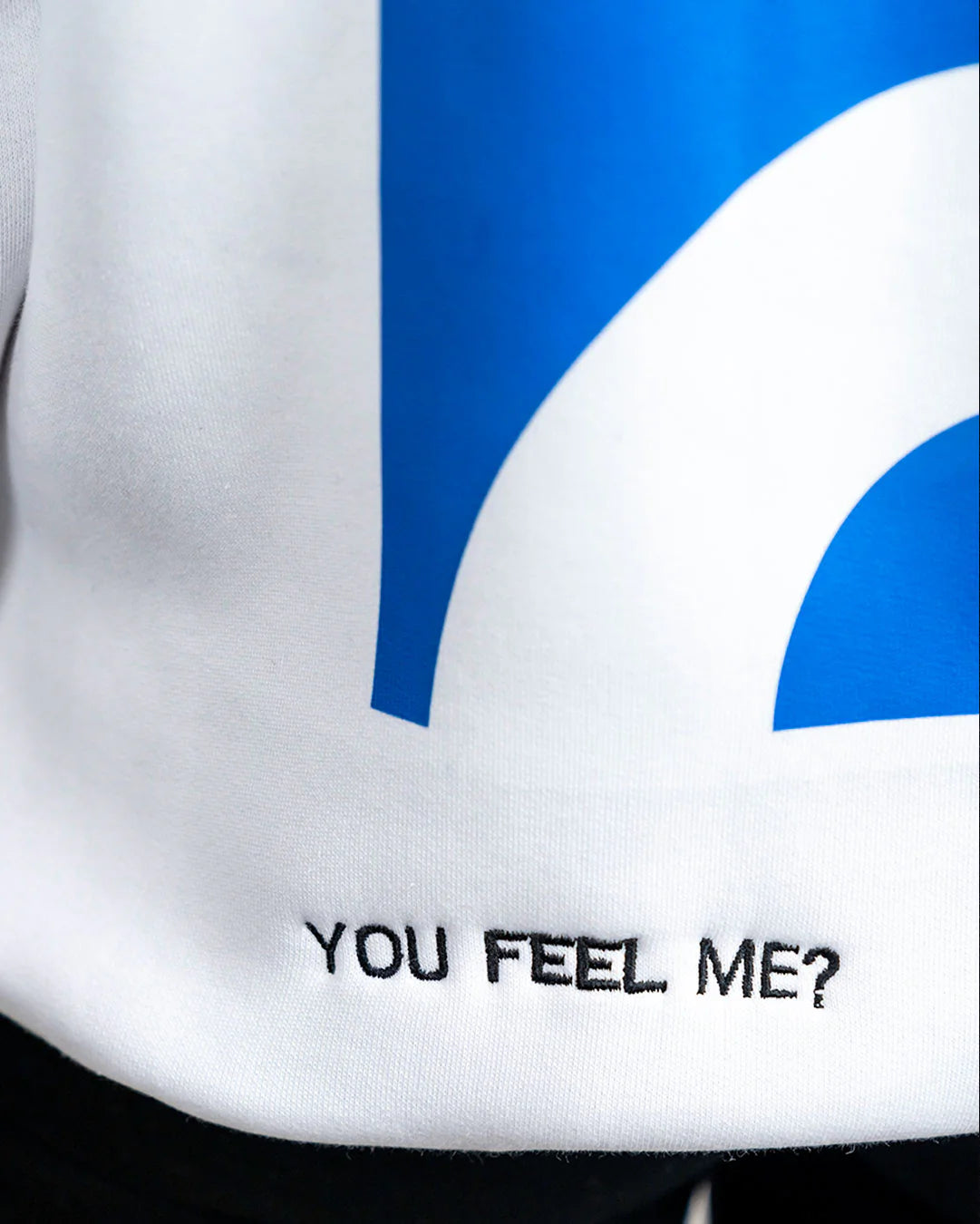 White shirt with blue design and text 'YOU FEEL ME?' on a black background