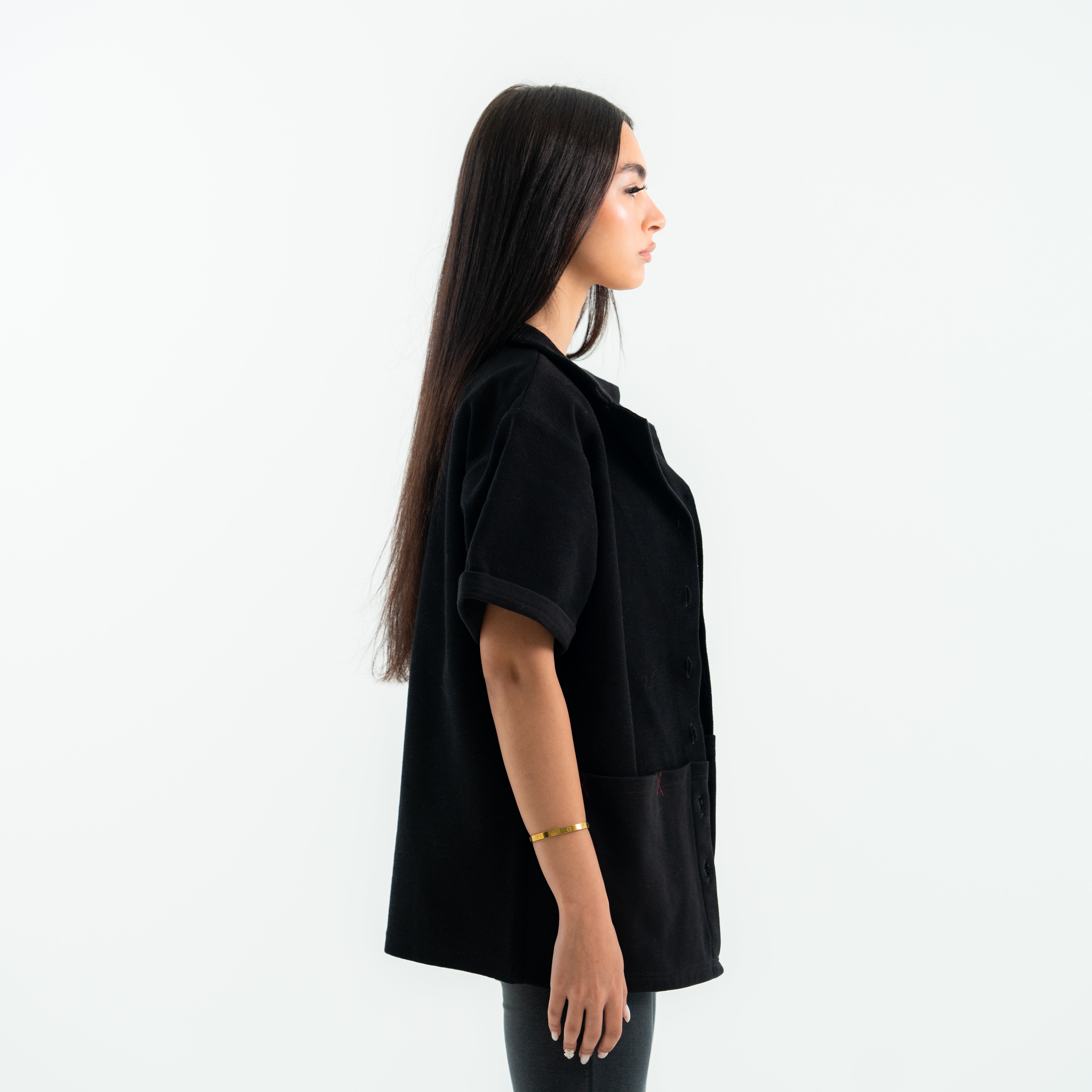 Woman wearing a black outfit on a white background