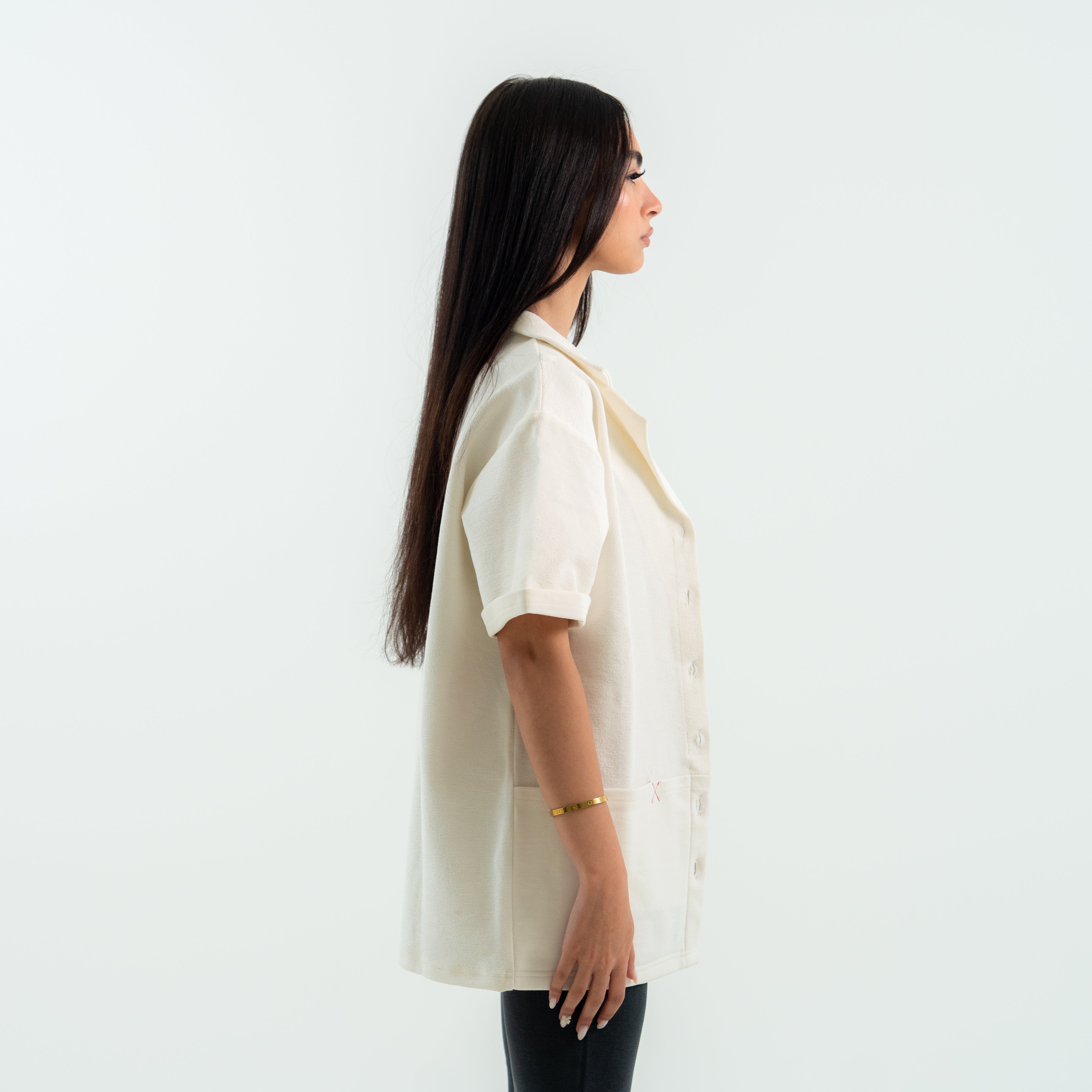 Woman wearing a beige blouse against a white background