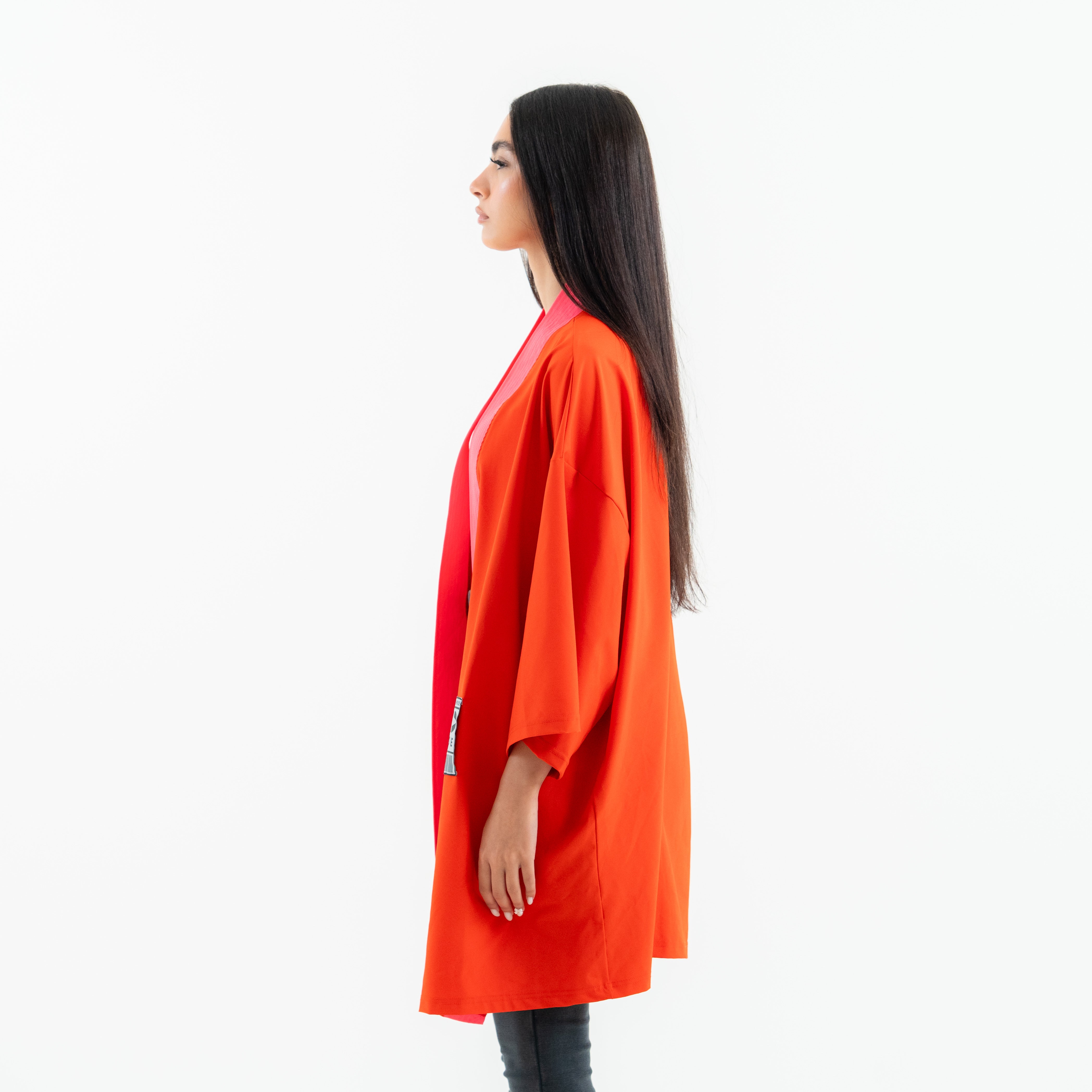 Woman wearing an orange coat on a white background