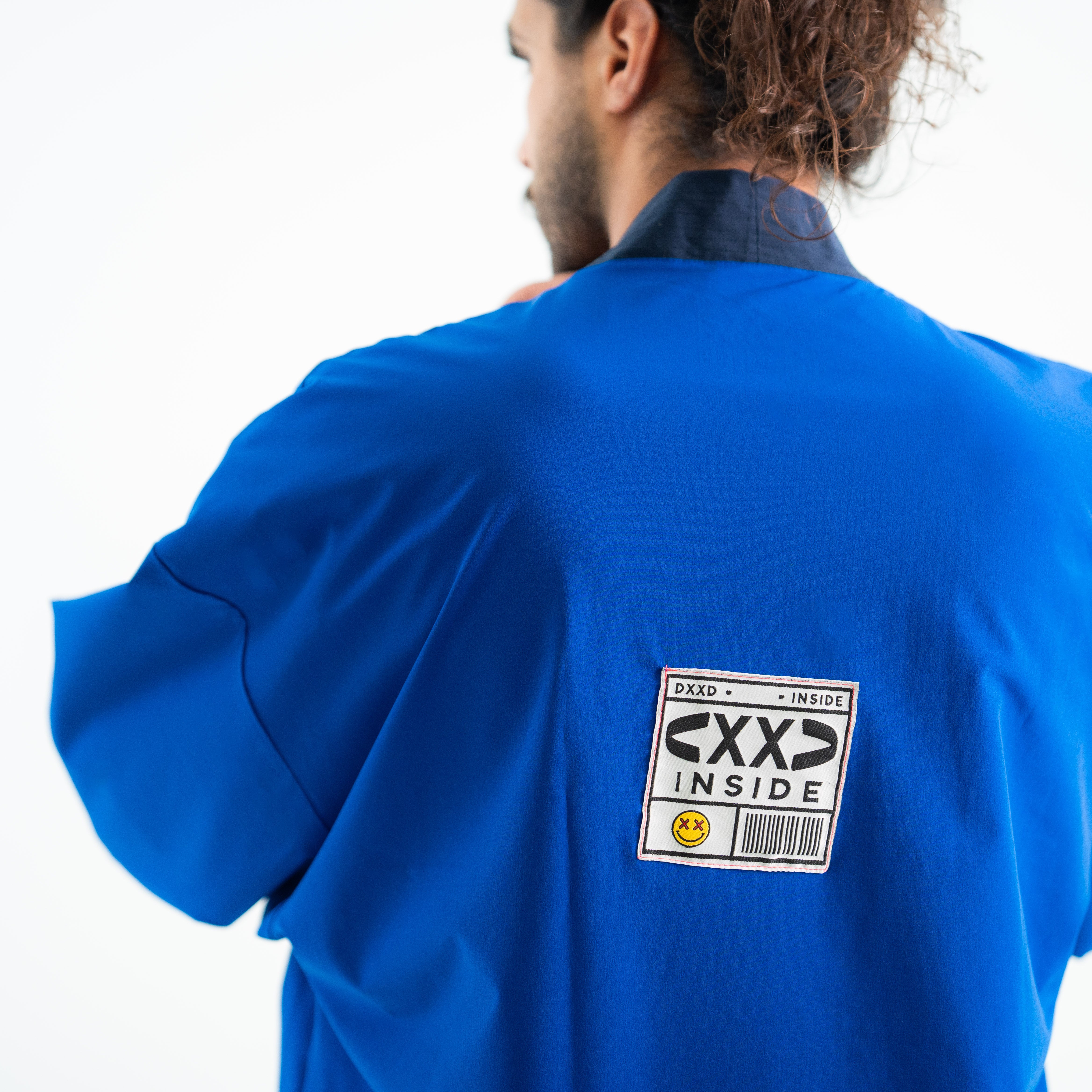 Person wearing a blue shirt with a label on the back
