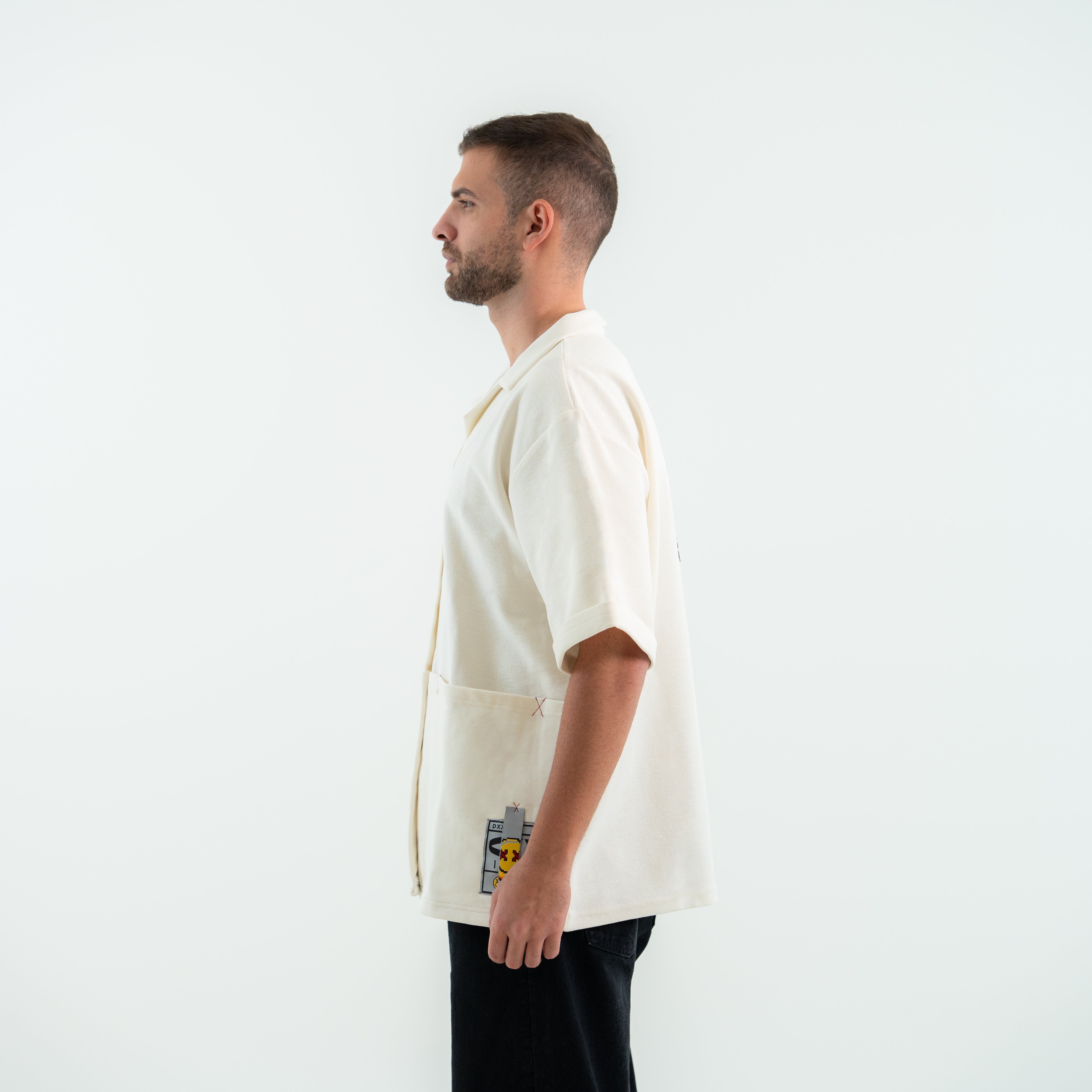 Man wearing a white apron with a logo on a plain background