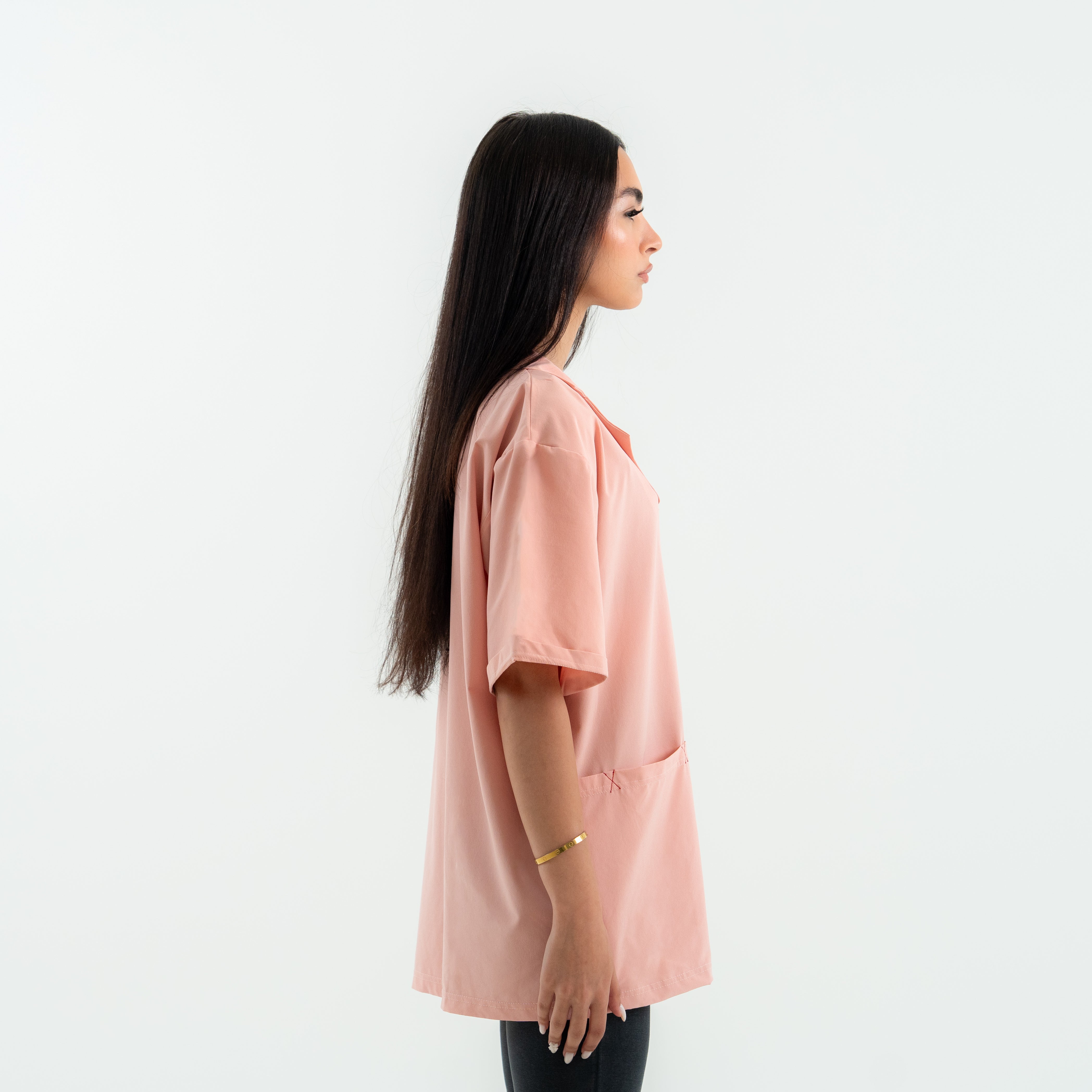 Woman wearing a pink blouse against a white background
