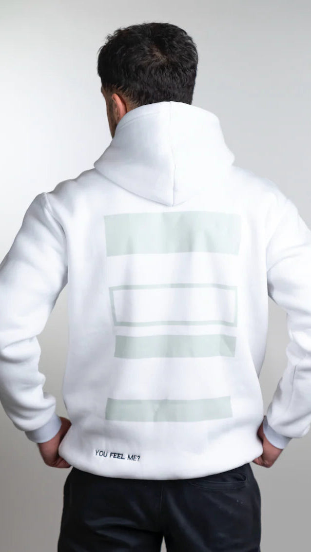 Person wearing a white hoodie with text on the back against a light gray background