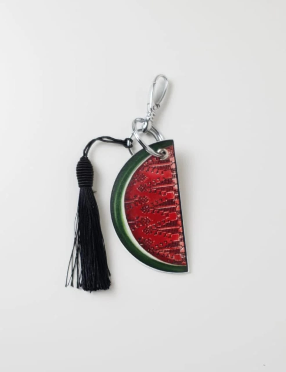 Keychain with watermelon design and tassel on a white background