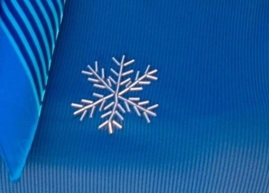 White snowflake design on a blue textured fabric background