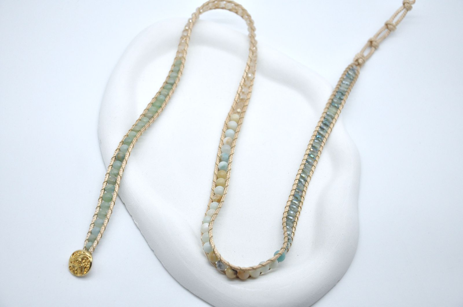Two beaded necklaces on a white background