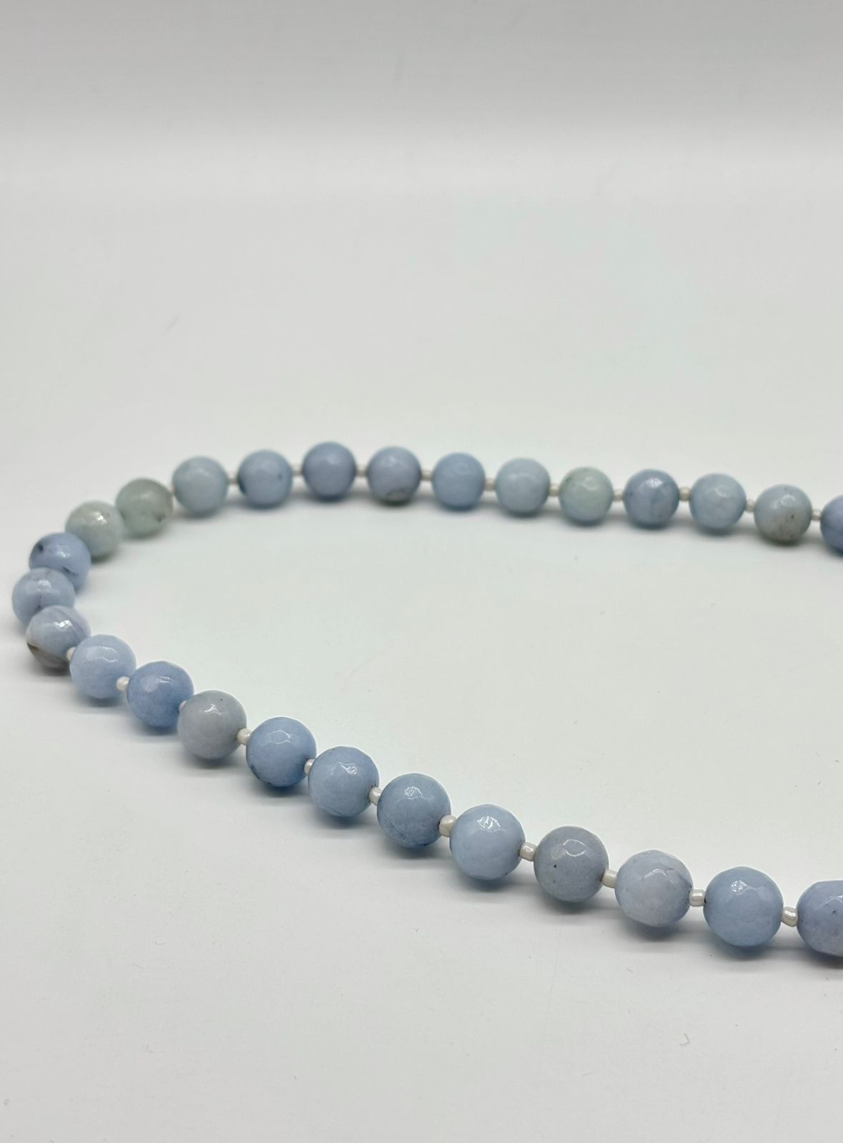 Necklace with blue beads on a white background