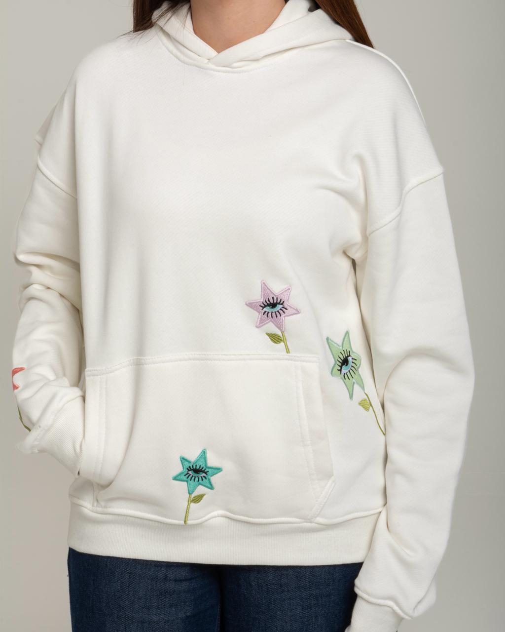 White hoodie with floral designs on a plain background