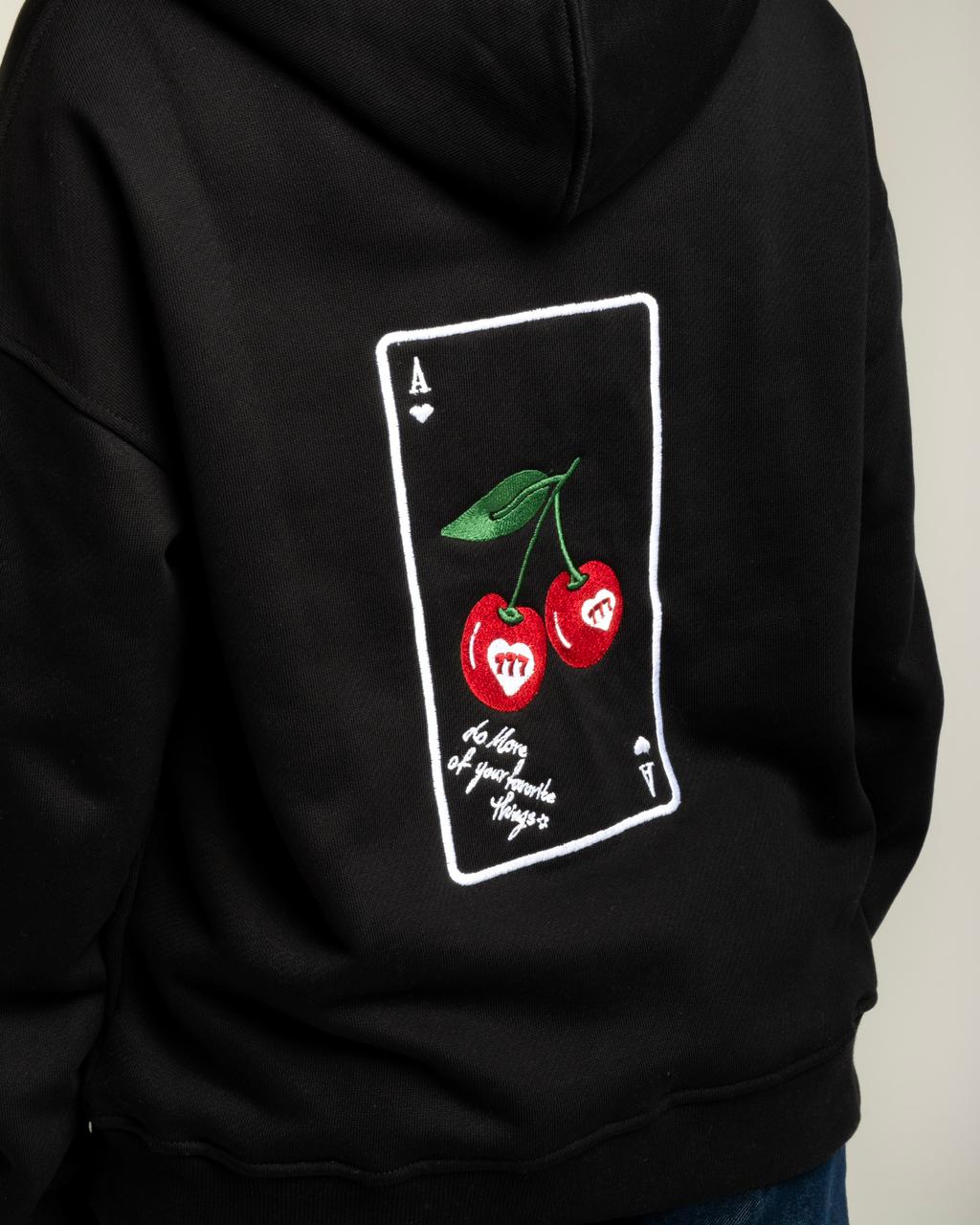 Black hoodie with a graphic design of cherries on the back