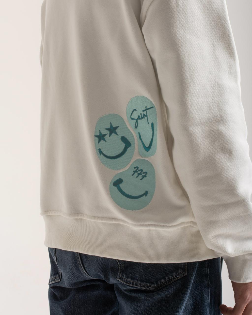 White sweatshirt with blue smiley face design on a plain background