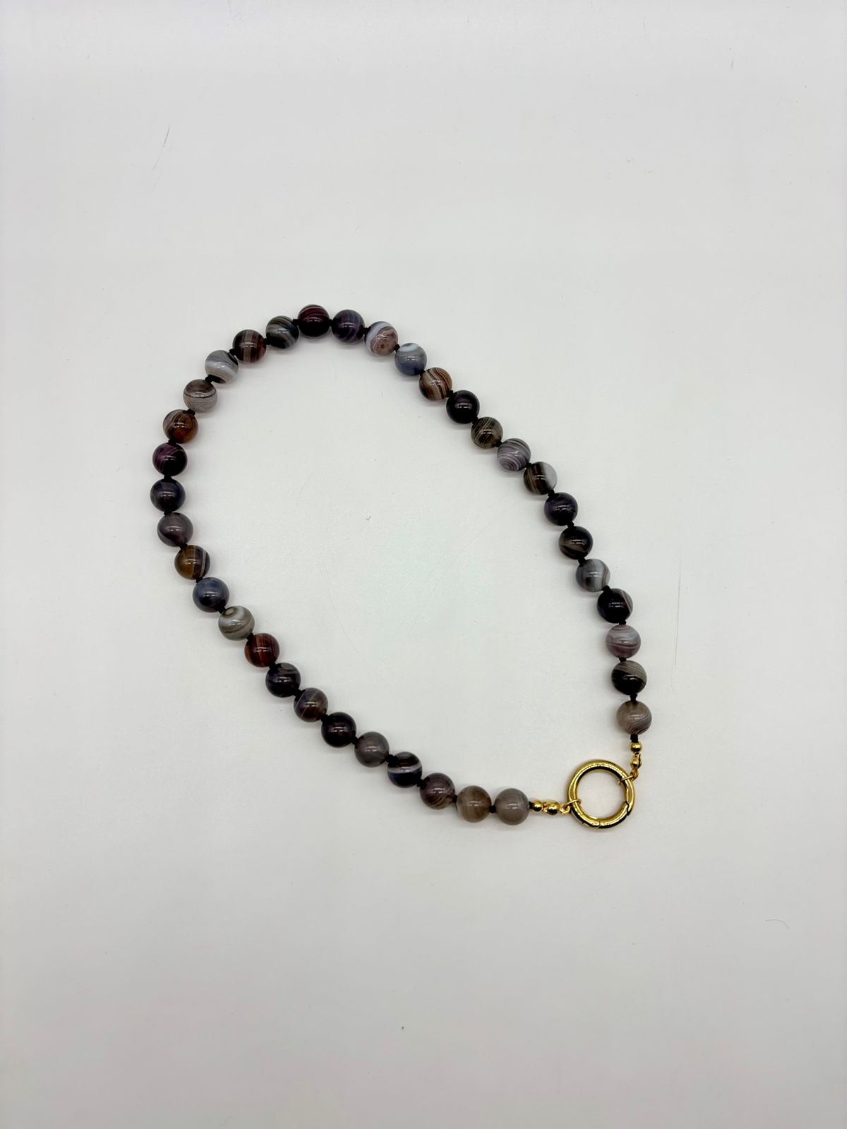 Beaded necklace with a gold clasp on a white background
