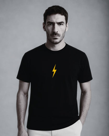 Man wearing a black t-shirt with a yellow lightning bolt on a gray background
