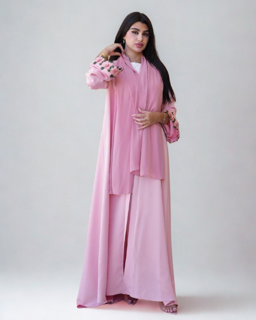 Woman wearing a pink traditional outfit with a white background